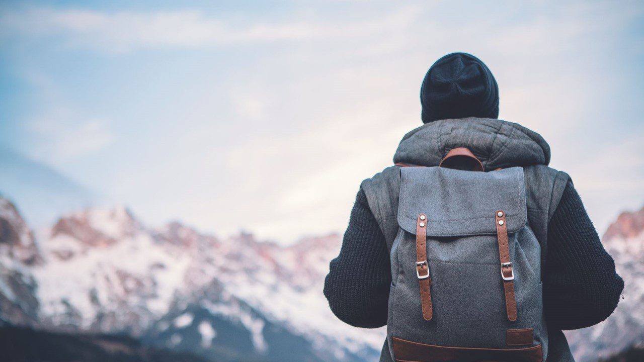 An Individual hiking in the snowy mountains