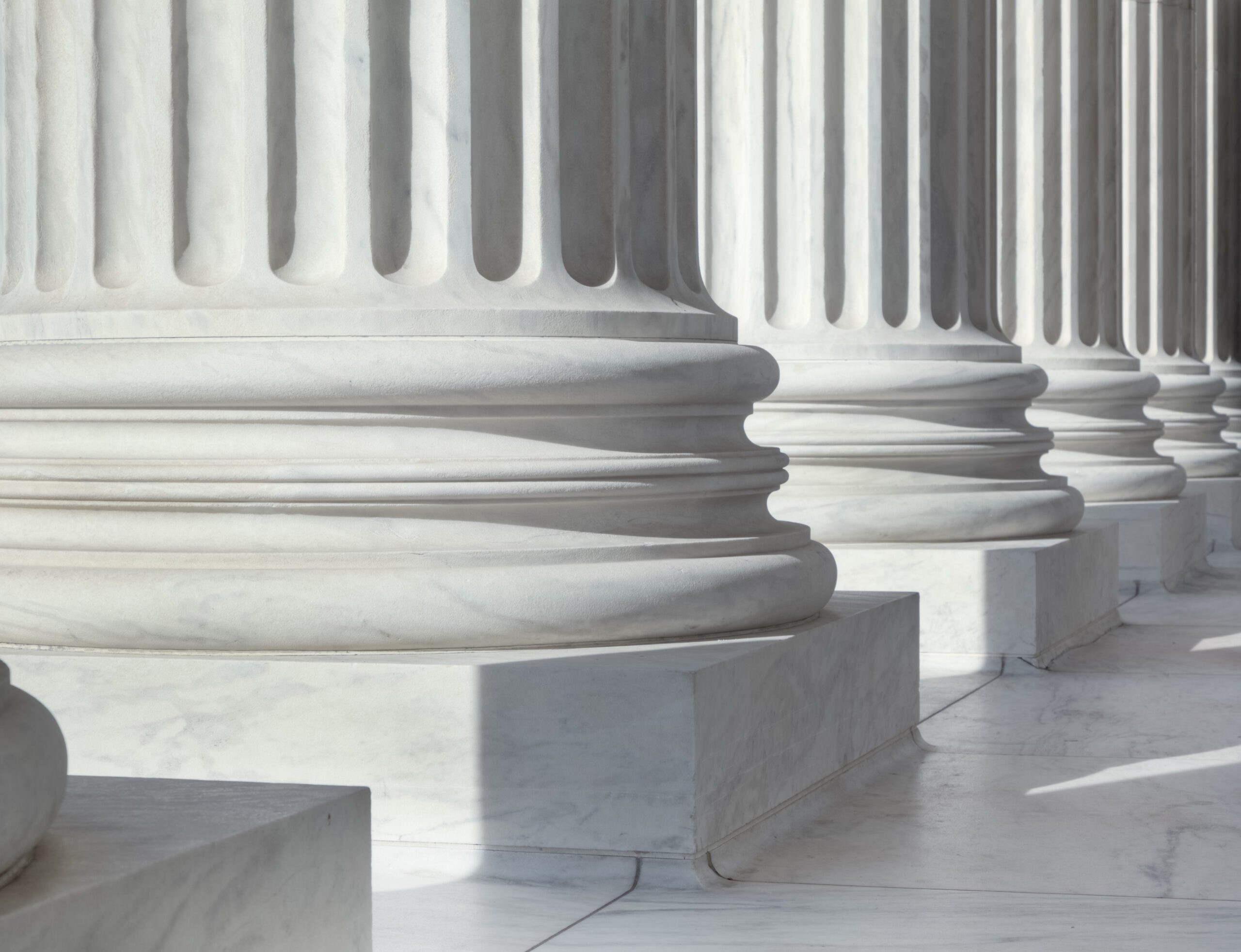 An image of architectural detail from the United States Supreme Court building. There are circular pillars visible in a row.