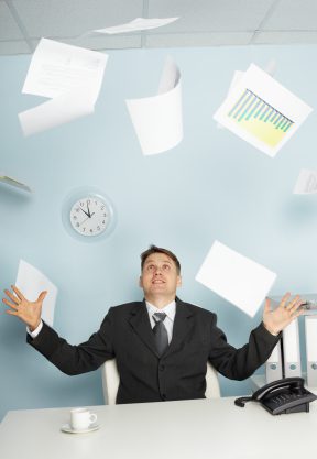 business man throwing paper with emotion at office