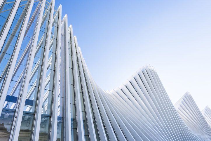 Architectural exterior white building train station structure in Italy.