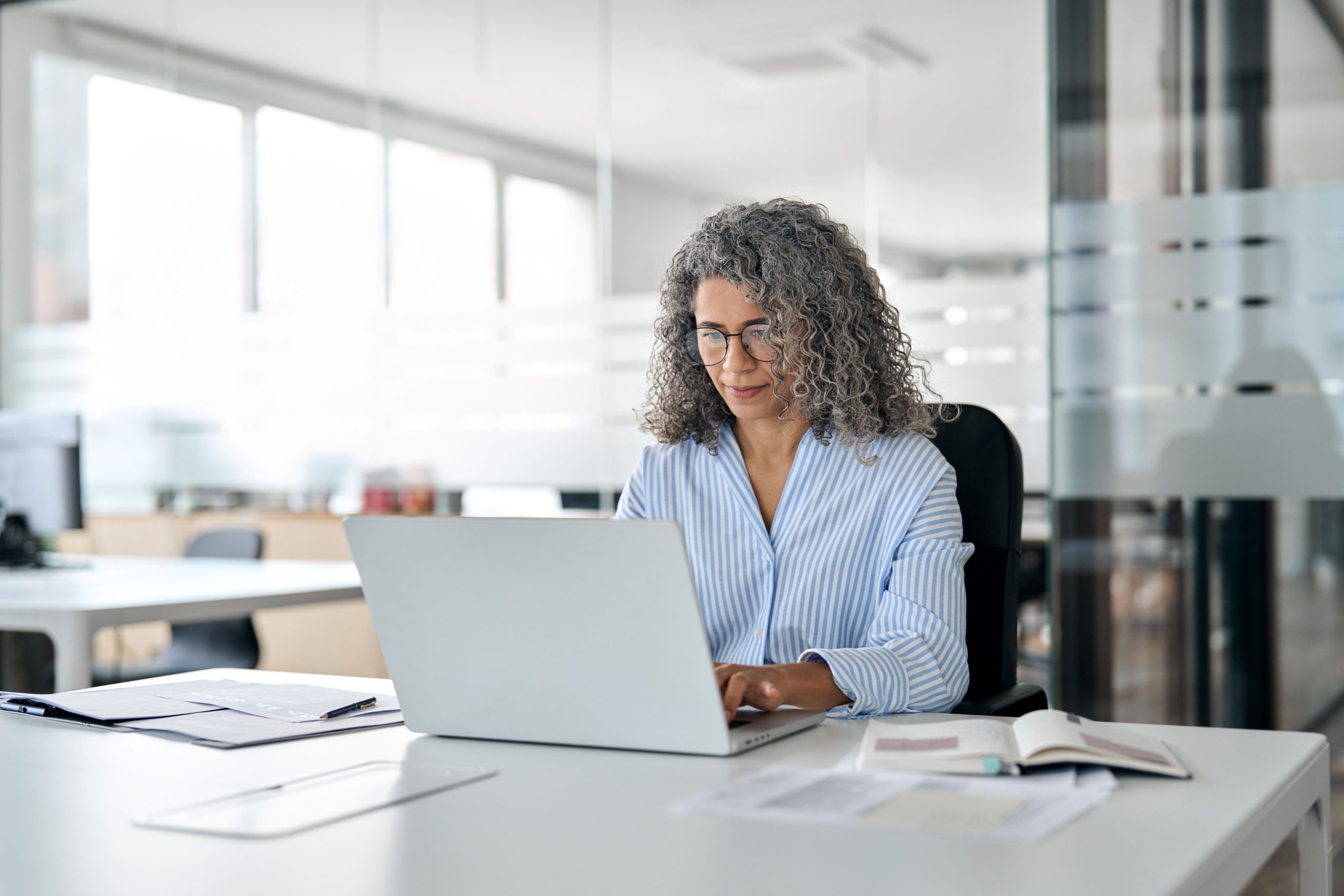 Business woman with laptop represents woman starting an RIA