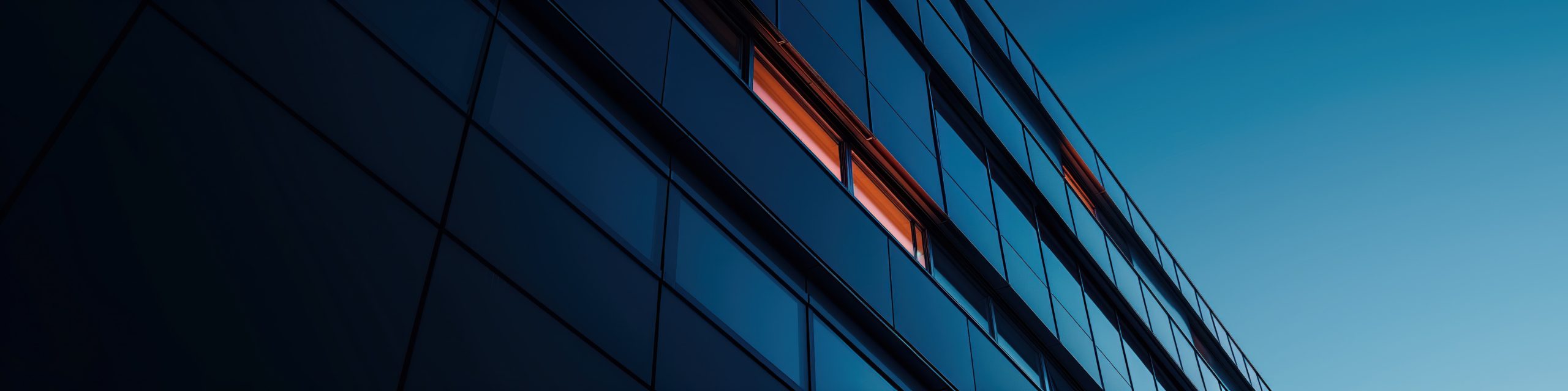 business building with orange office light represents branch office exams