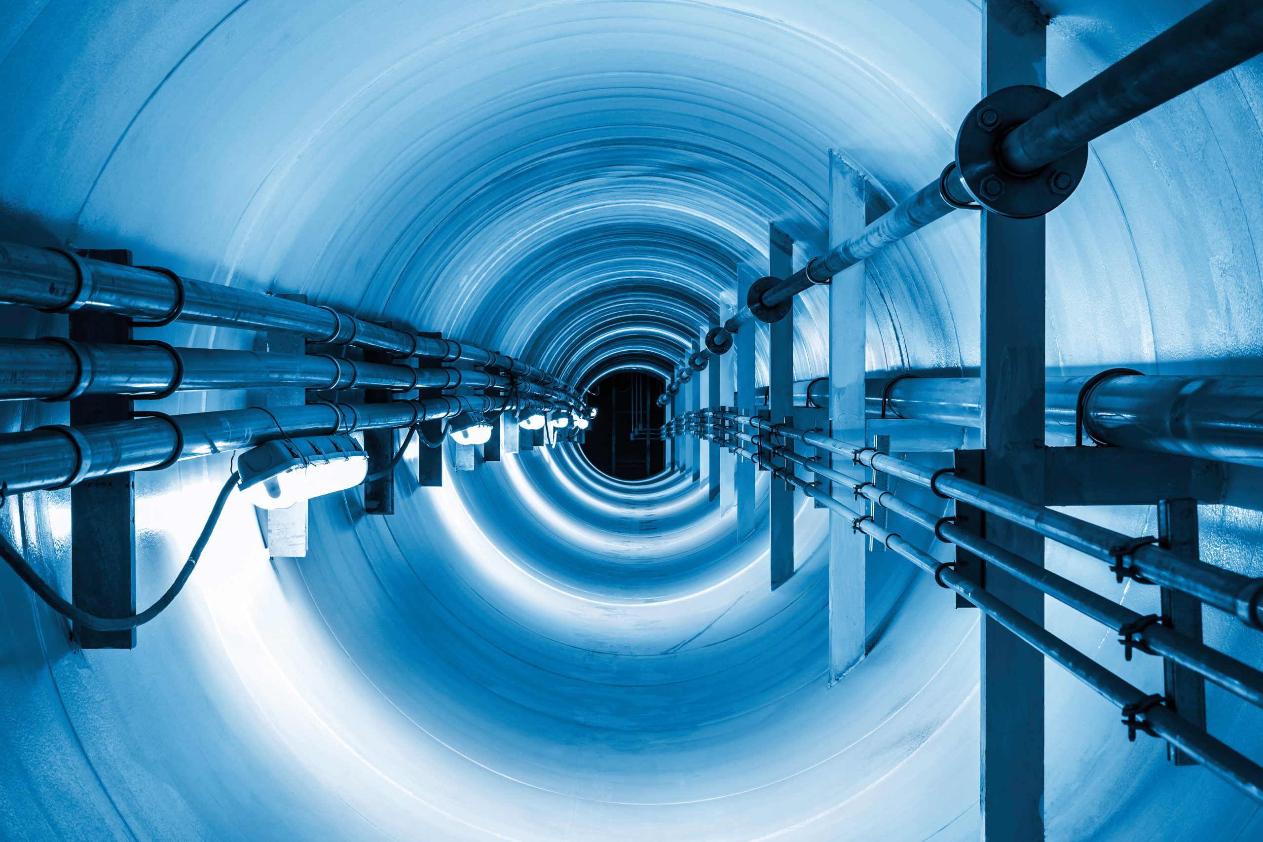 Steel pipe and pipeline inside underground tunnel representing aligning growth and infrastructure