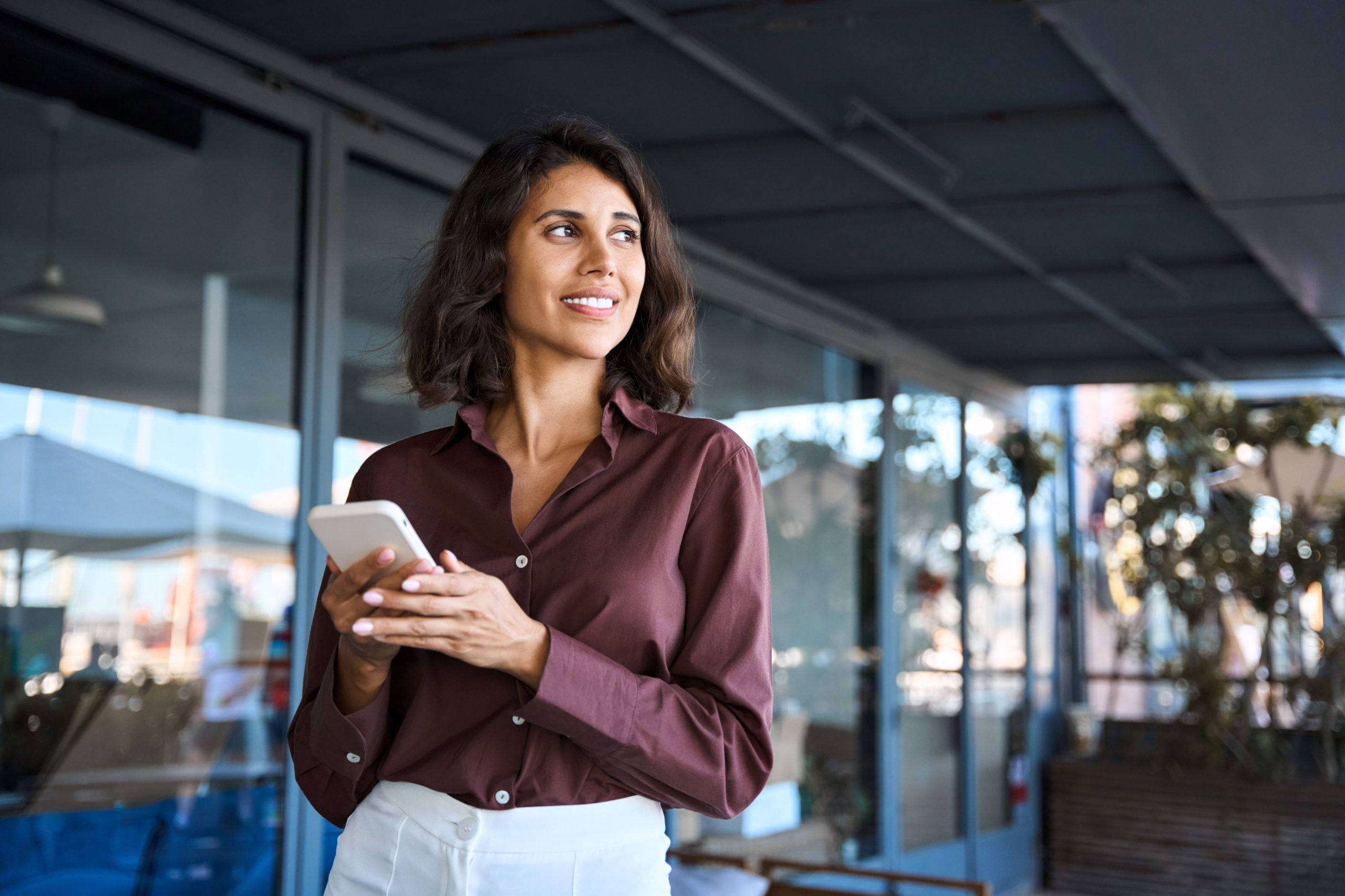 business woman texting on cell phone represents communicating compliantly