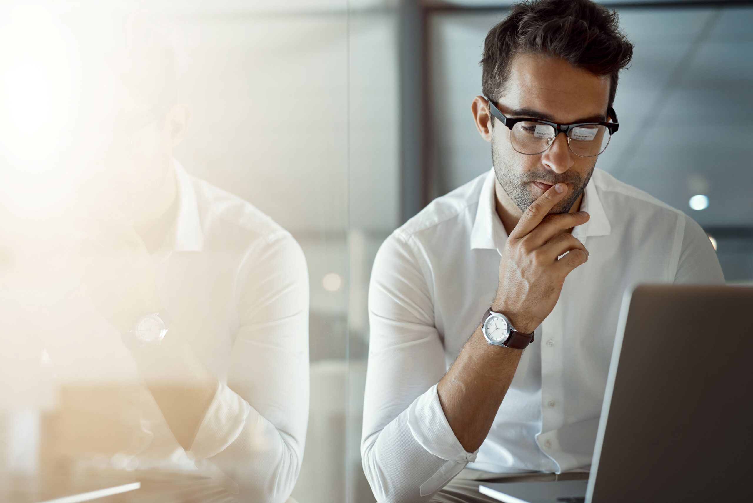 Business exec at laptop represents operational resiliency