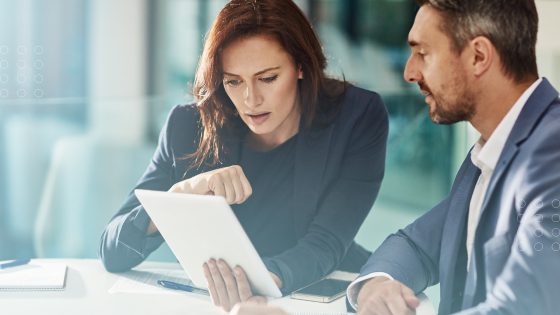A wealth management firm female and male employees selecting back office technology.