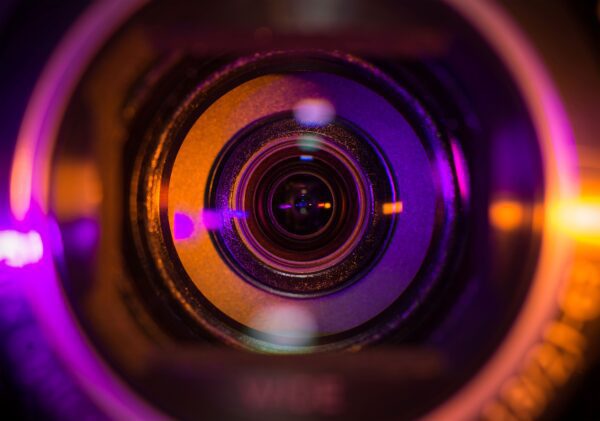 pink and orange camera lens represents REG SCI compliance