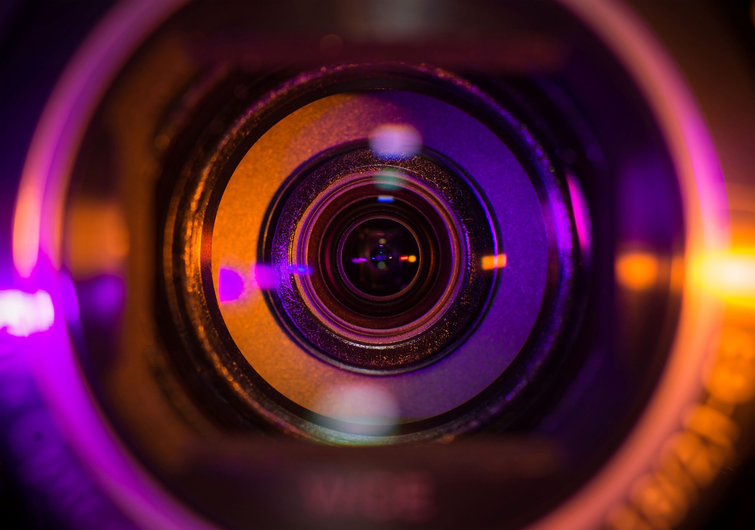 pink and orange camera lens represents REG SCI compliance