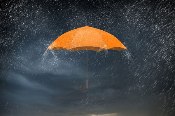 orange umbrella in rain represents protecting Vulnerable adults