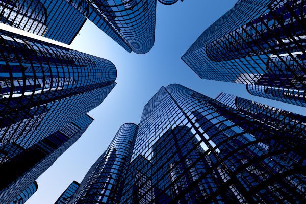 upward view of office buildings represents benchmarking for success